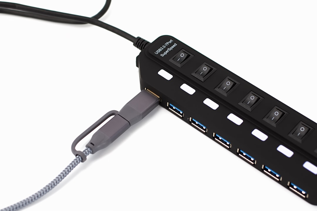 Black usb hub with multiple ports and switches.